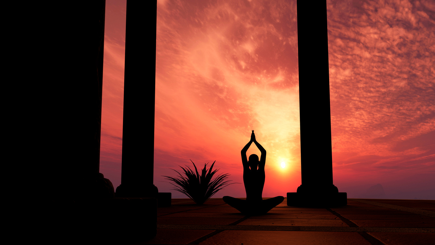 Silhouette practicing yoga