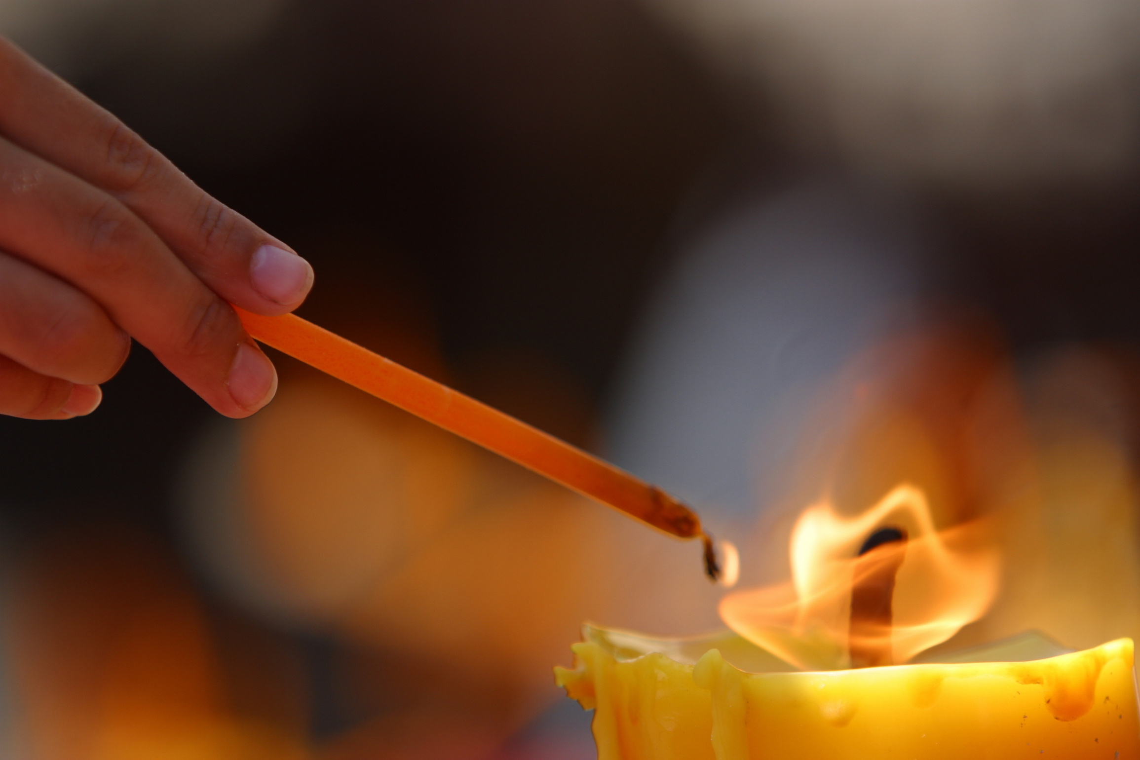 Person lighting spiritual candle